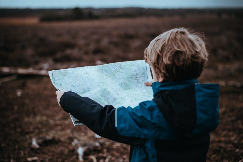 young child with map - How to Take Young Children on Vacation
