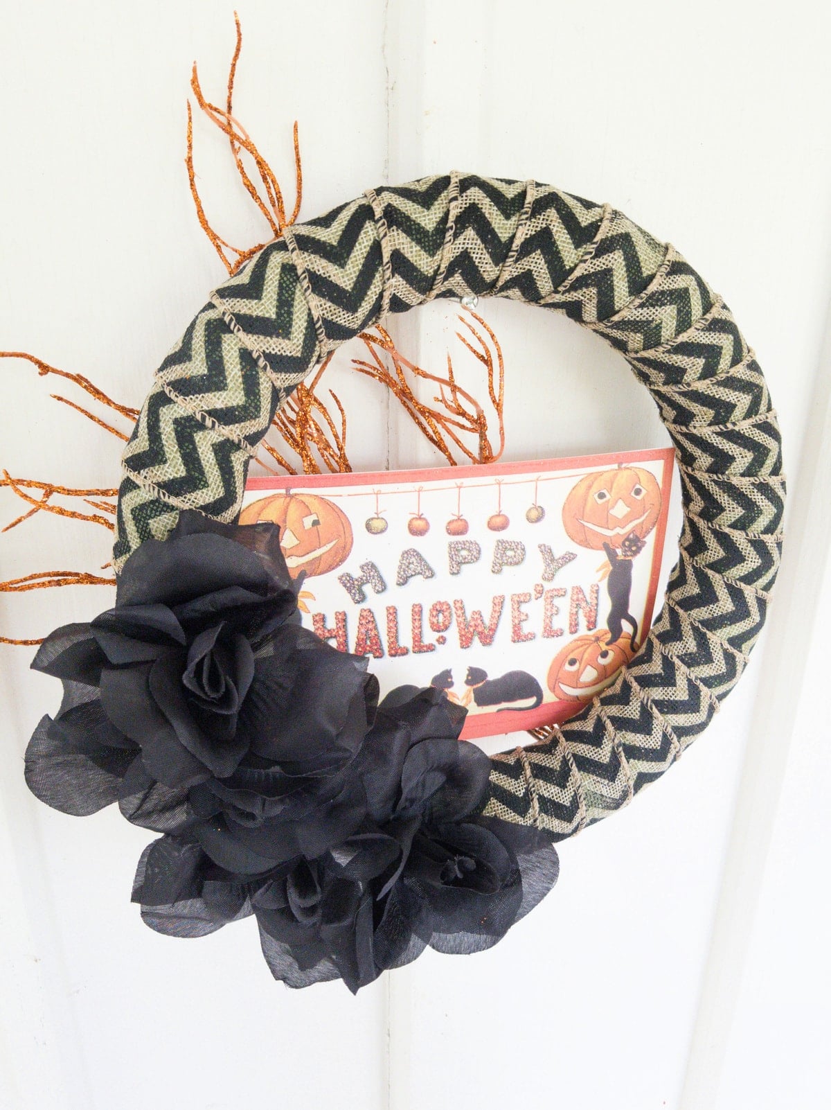 Happy Halloween wreath on white wall