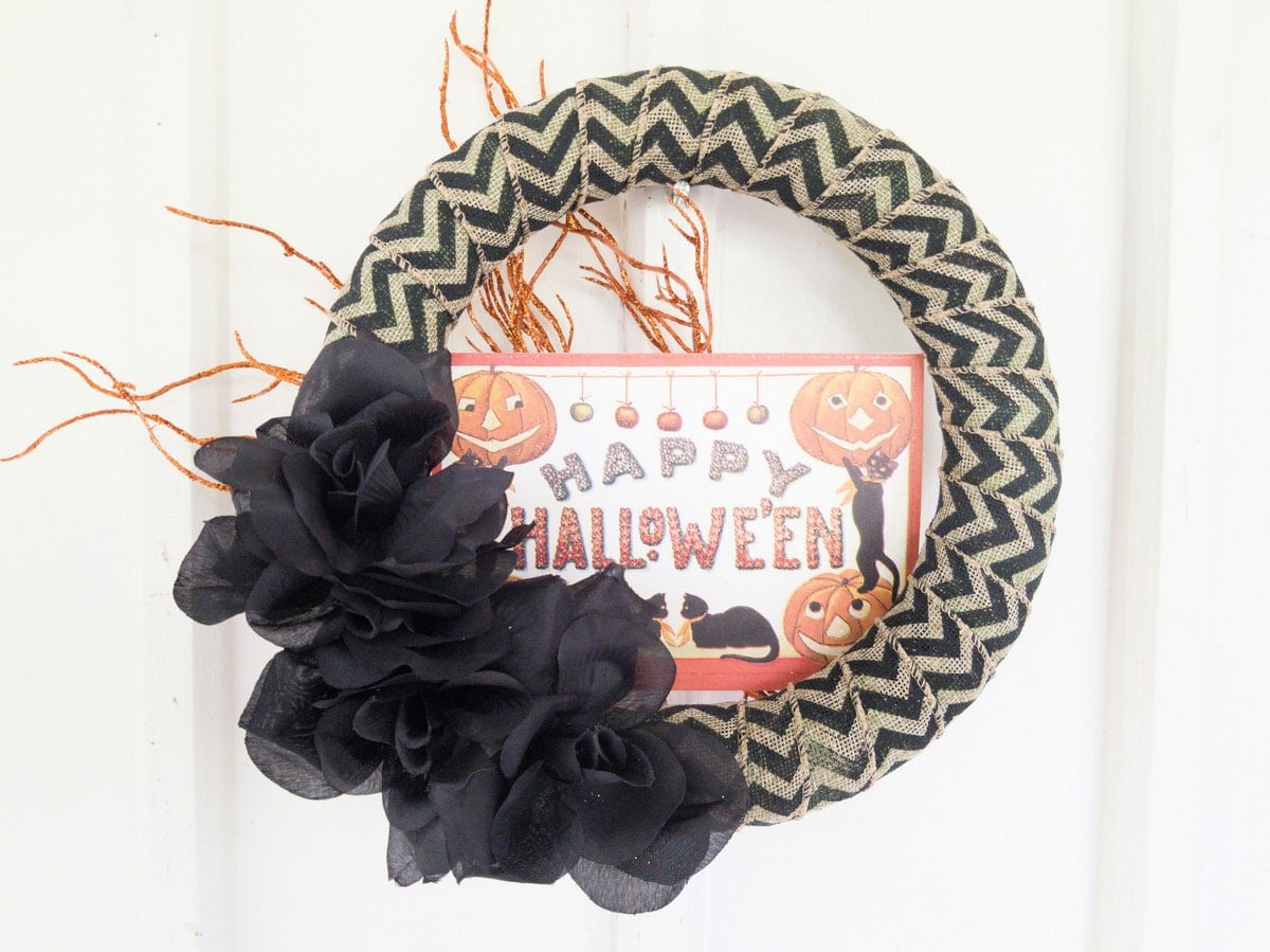 Happy Halloween wreath on white wall