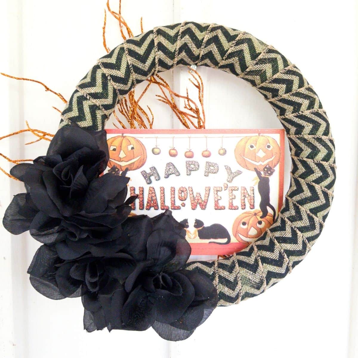 Happy Halloween wreath on white wall