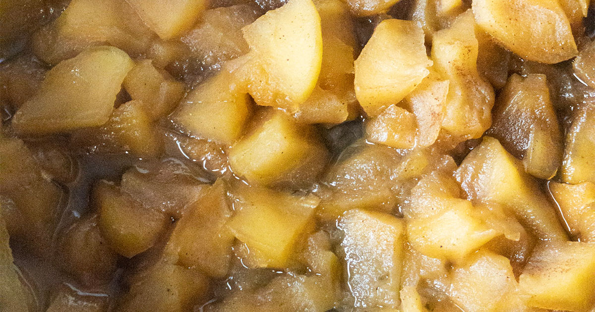 in-process step of apple butter being cooked in the crockpot