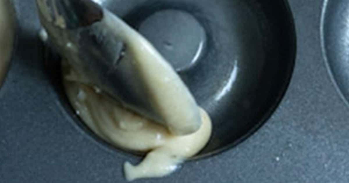 in-process step of putting batter in a pan to make apple pie