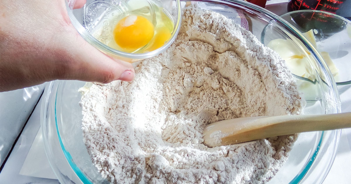 gingerbread cookie dough being mixed with eggs
