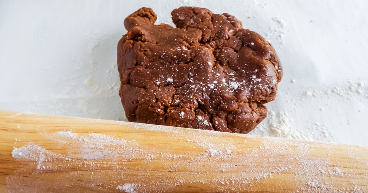 gingerbread man cookie dough being rolled out