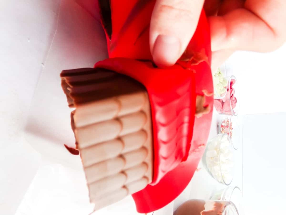 Gingerbread House Hot Cocoa Bombs being removed from a mold