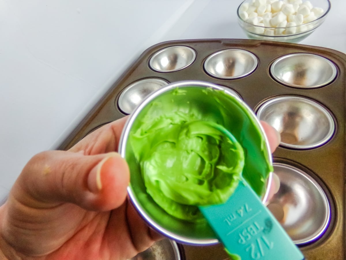 in-process step of filling molds to make Christmas Hot cocoa bombs