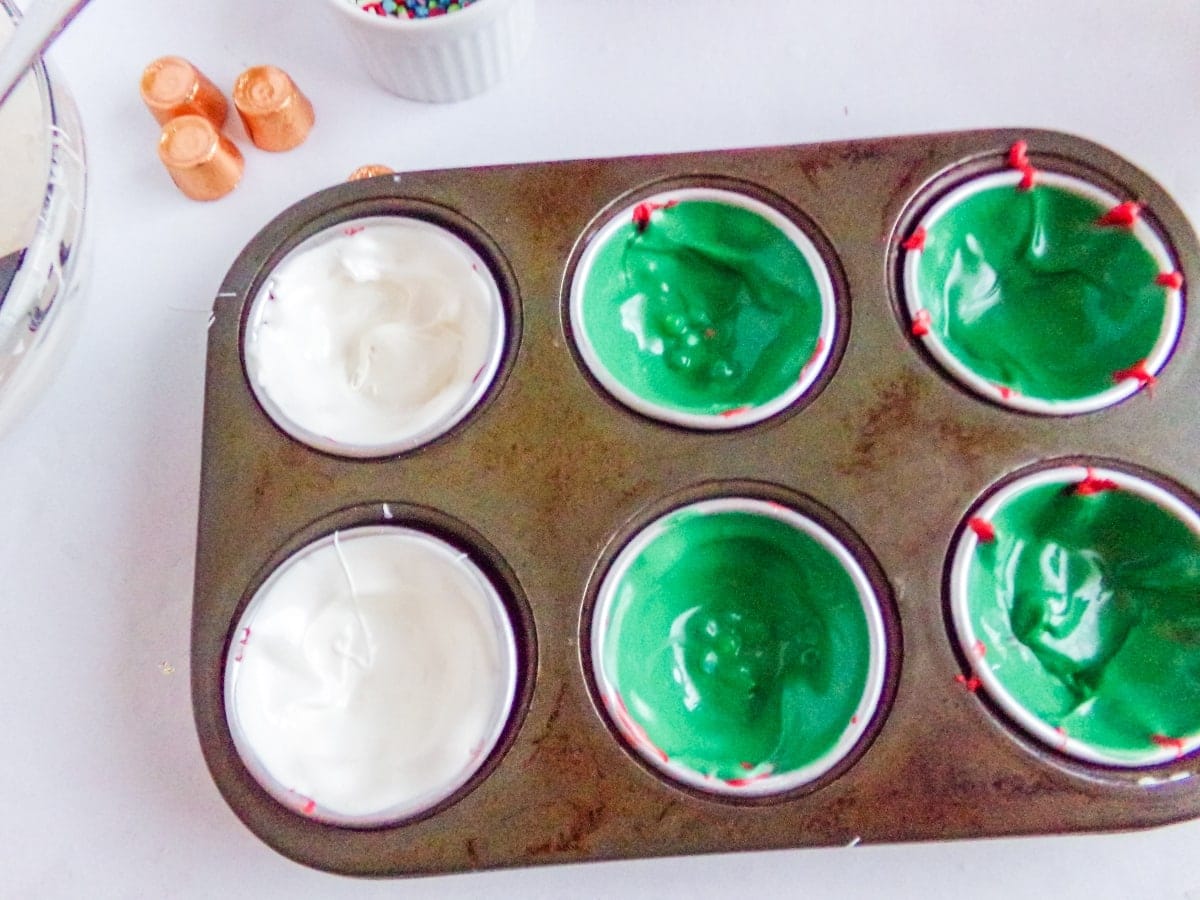 in-process step of filling molds to make Christmas Ornament Hot cocoa bombs