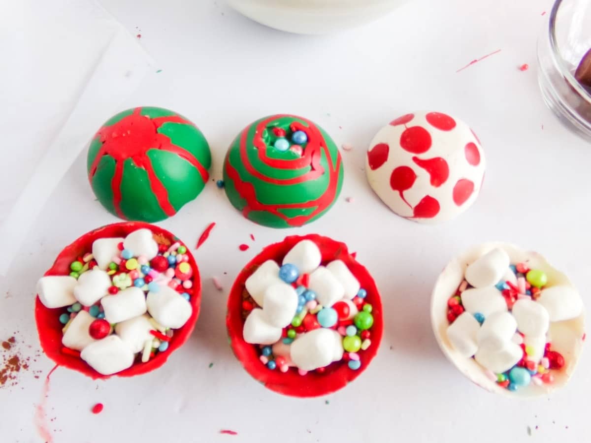 in-process step of filling Christmas Ornament Hot cocoa bombs