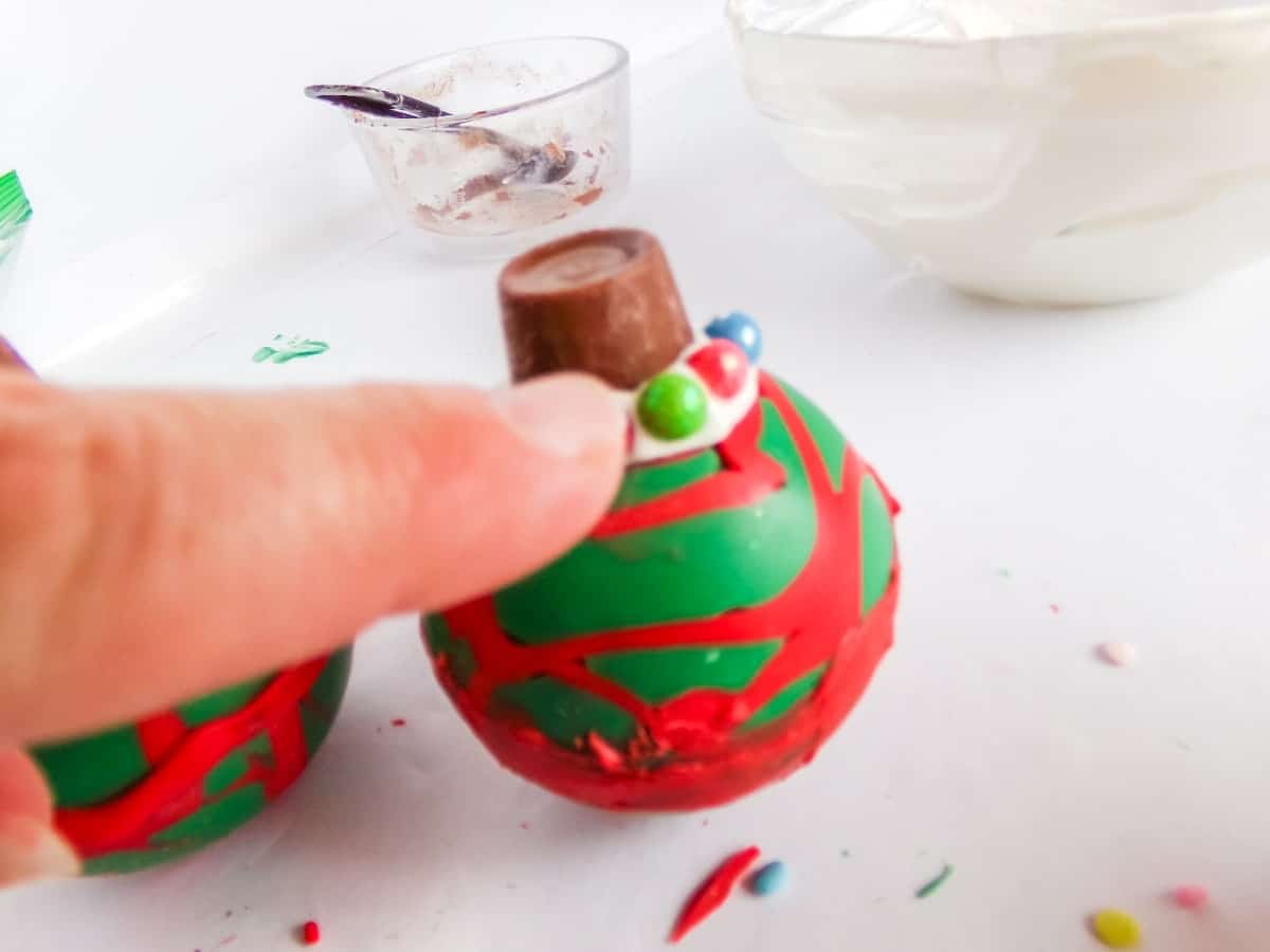 in-process step of decorating Christmas Ornament Hot cocoa bombs