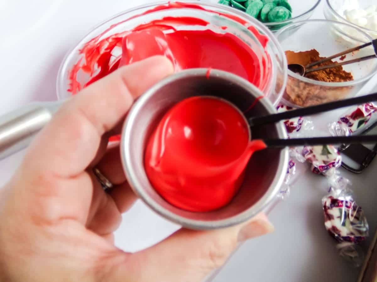 in-process step of filling molds to make Christmas Taffy Hot Cocoa Bombs