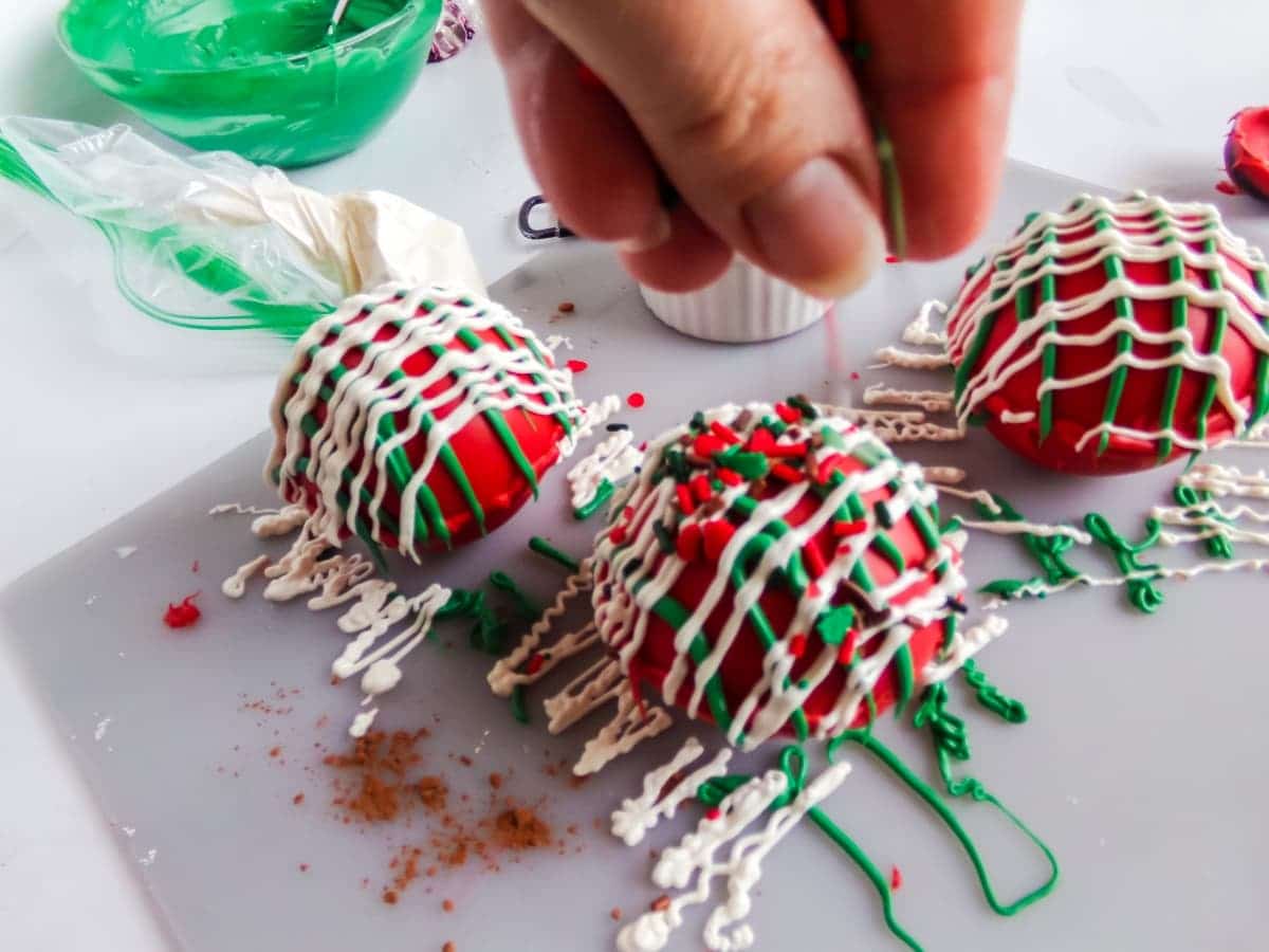 in-process step of decorating Christmas Taffy Hot Cocoa Bombs