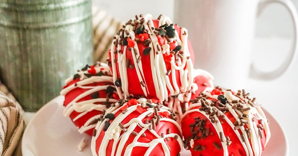 Mickey Hot Cocoa Bombs on a white plate with a mug