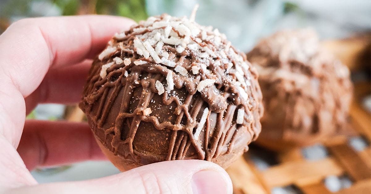 hand holding Mounds Hot Cocoa Bombs