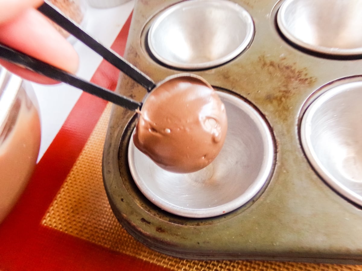 filling molds to make Mounds Hot cocoa bombs