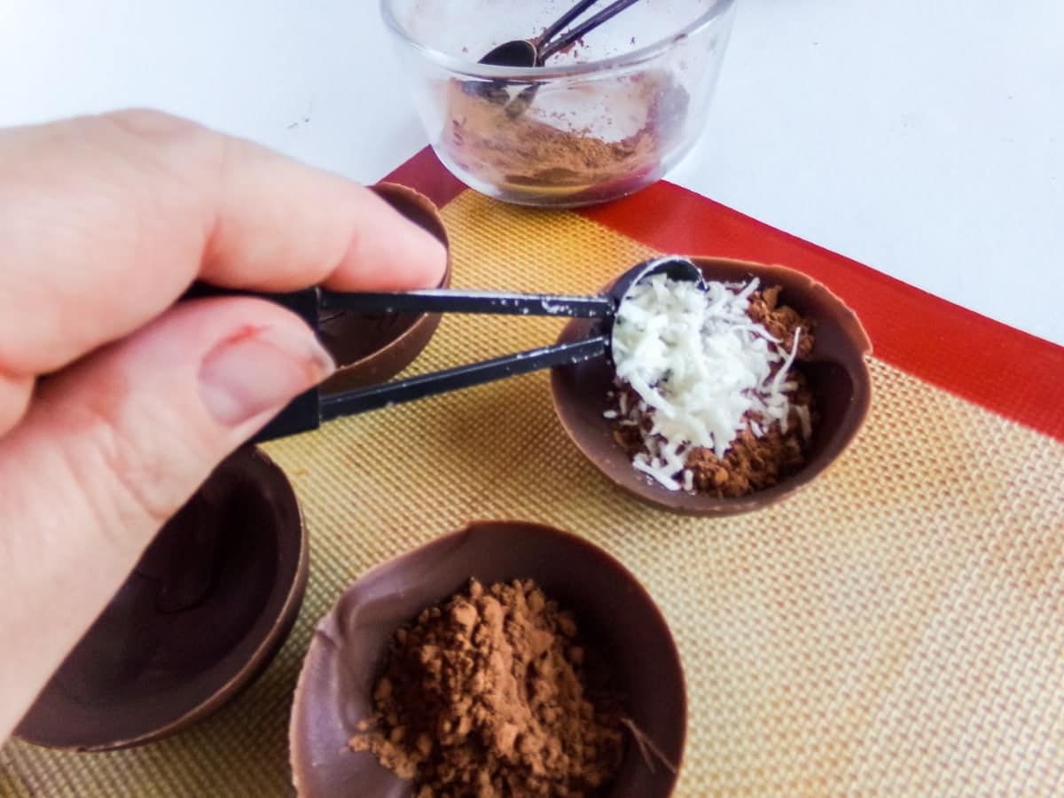 filling homemade Mounds Hot cocoa bombs