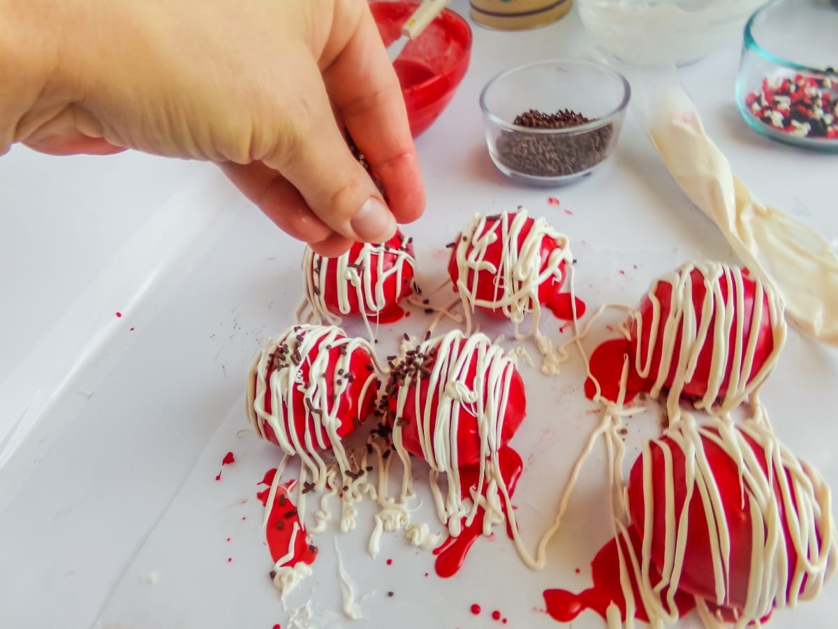 adding decorations to mickey hot cocoa bombs