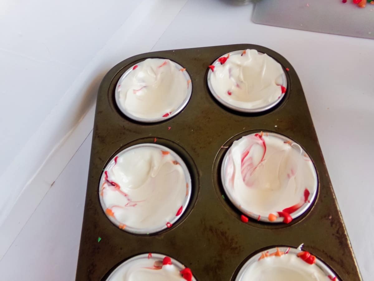 molds filled with candy melts to make old fashioned Christmas Candy Hot cocoa bombs