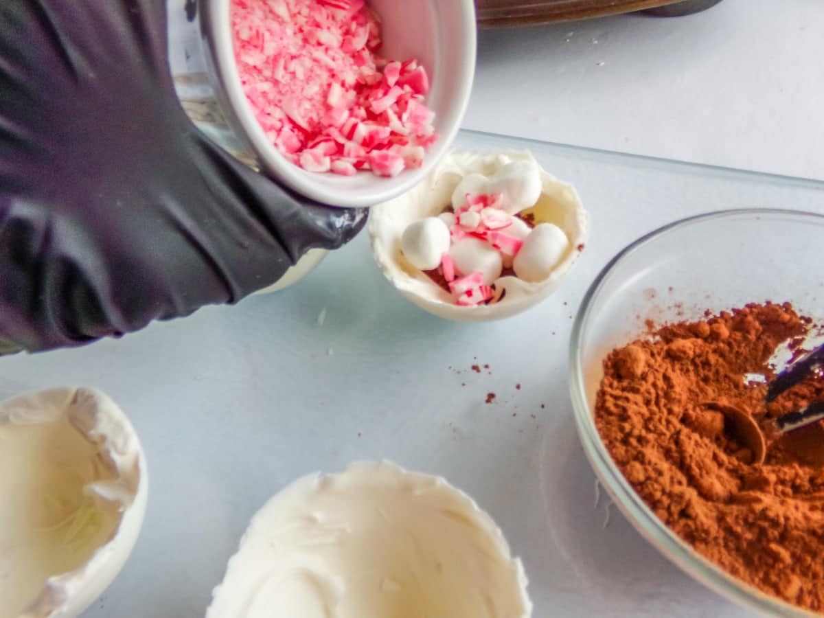 in-process step of adding crushed peppermints to make peppermint hot cocoa bombs