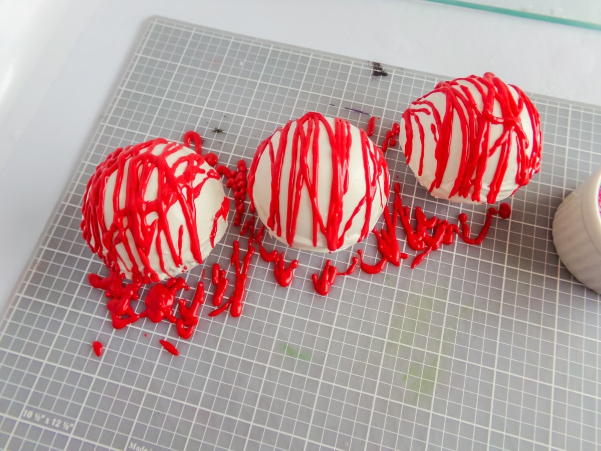 in-process step of decorating peppermint hot cocoa bombs