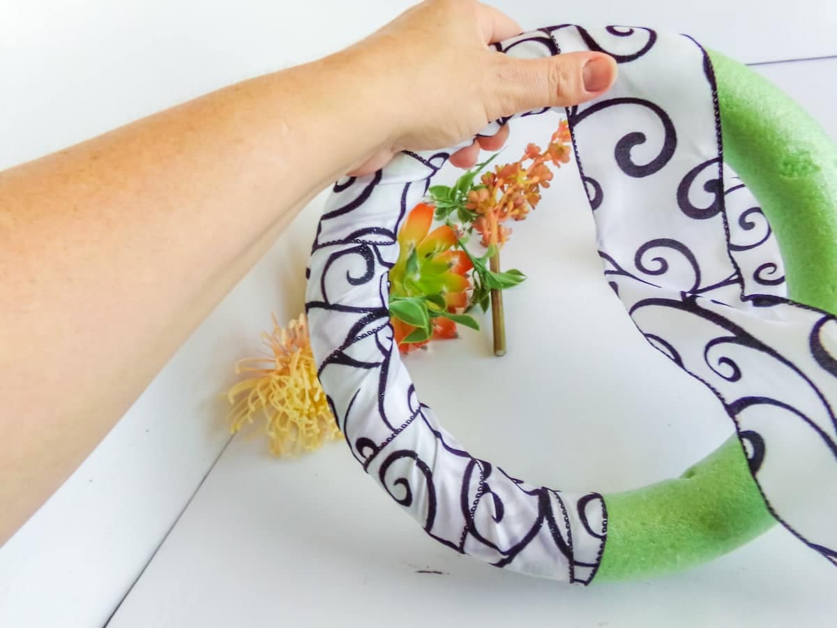 wrapping ribbon around a wreath form to make a succulent wreath