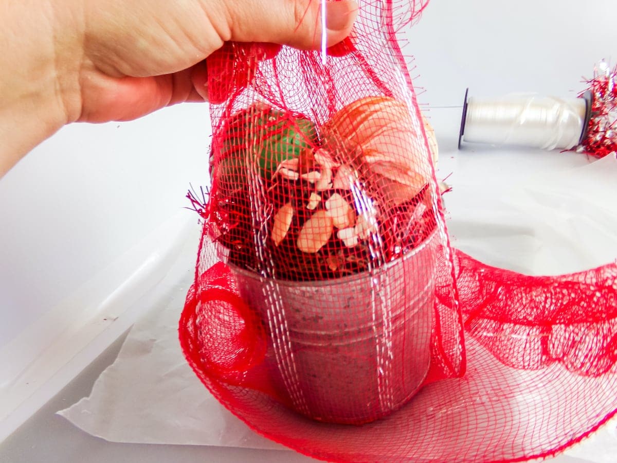 wrapping a diy neighbor gift basket of hot cocoa bombs