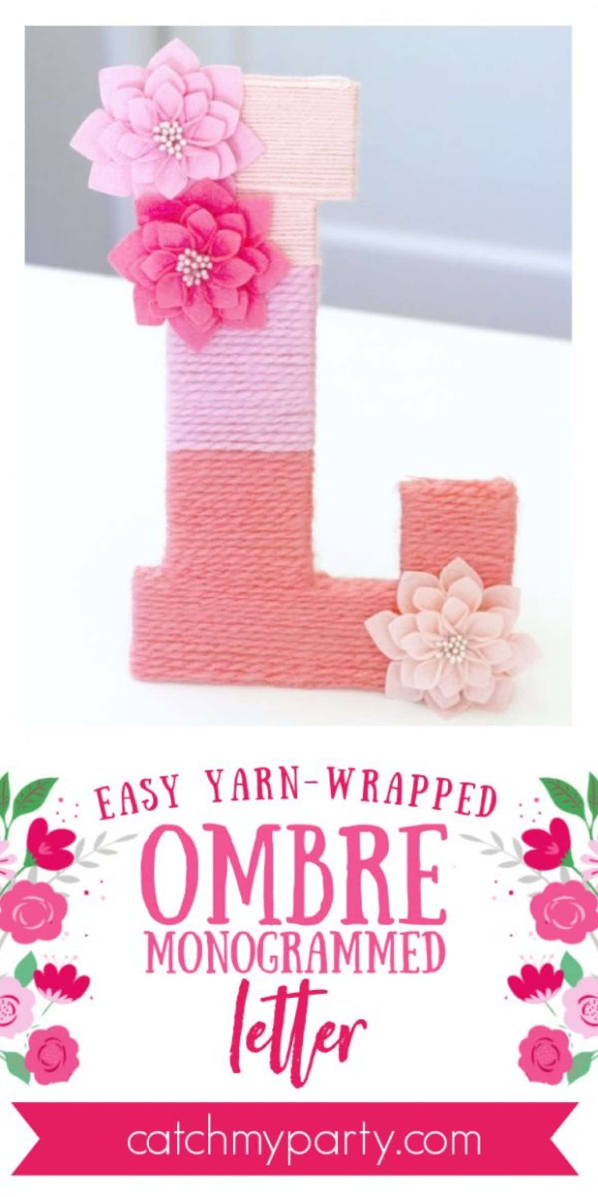 At the bottom of the page is the pink text "easy yarn-wrapped ombre mongrammed letter" On a white surface is the letter "L" with yarn wrapped around it in pink and orange. Attached to the top and bottom are 3 felt flowers in pink and cream