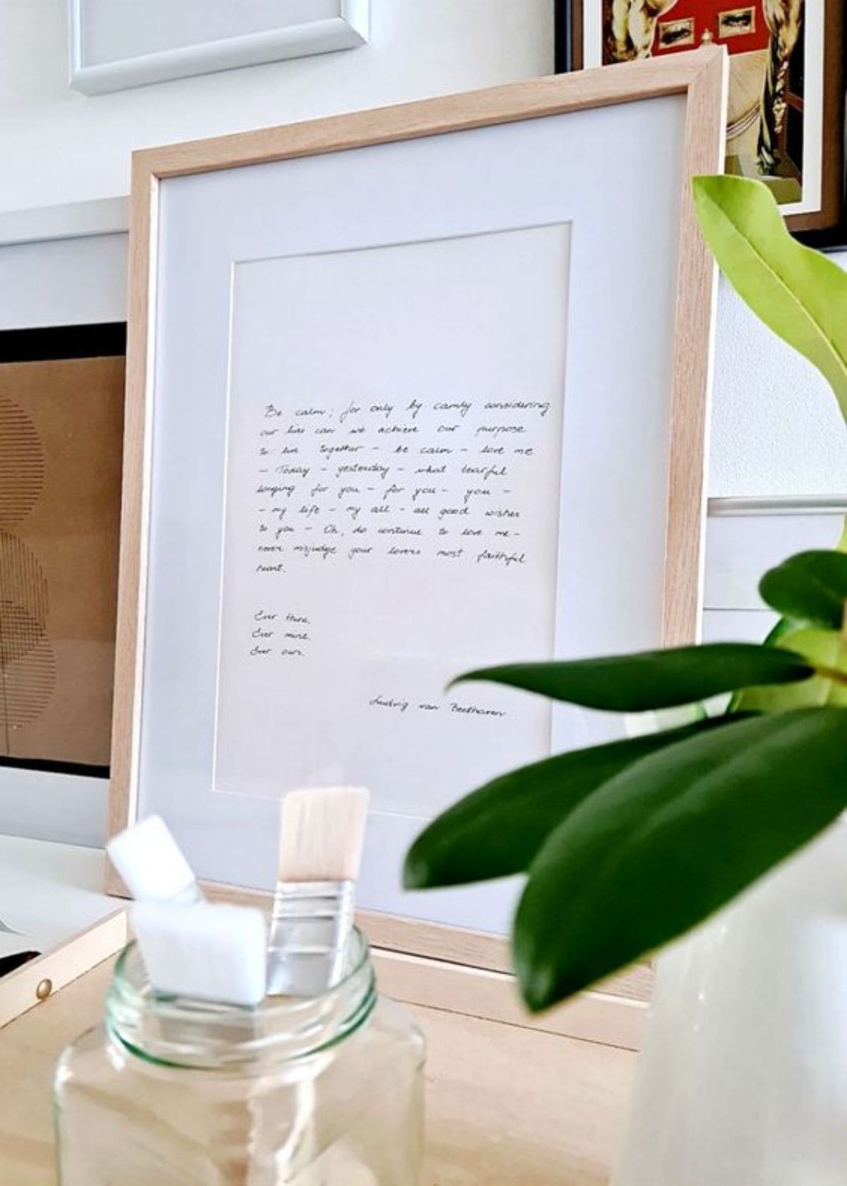 a framed love letter sits on a table