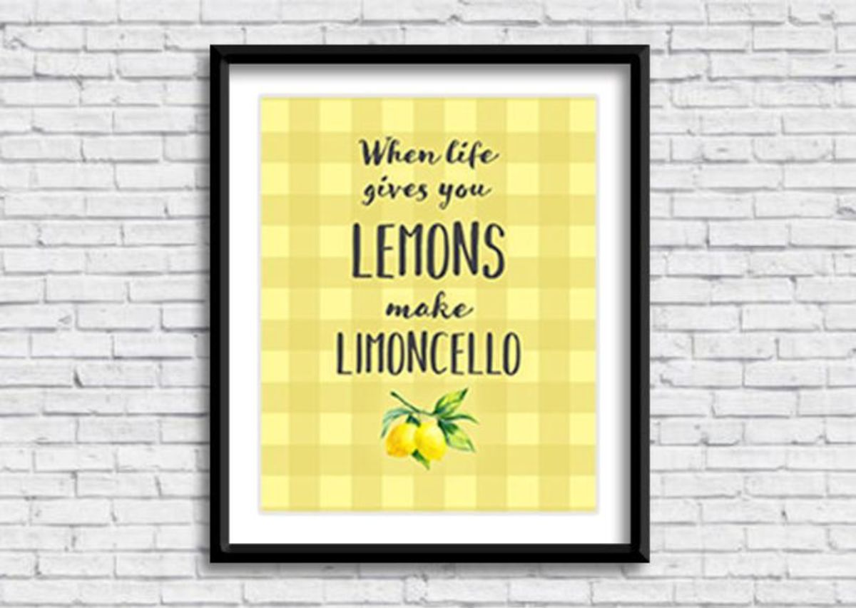 On a white brick background is a black frame with a yellow picture. The words in black are "When life gives you lemons make limoncello"