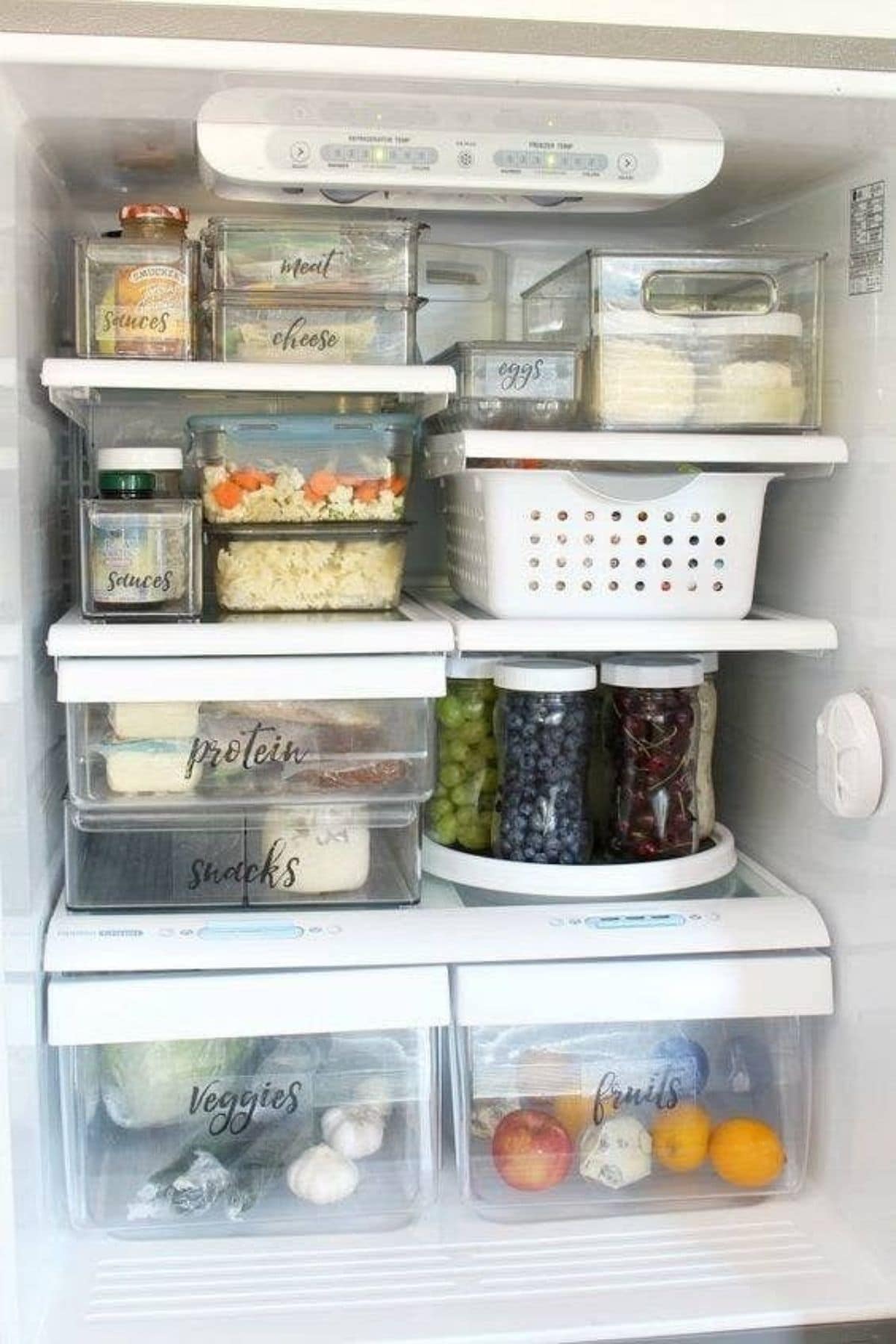 A view of frisge shelves with glass boxes of various sies on each shelf