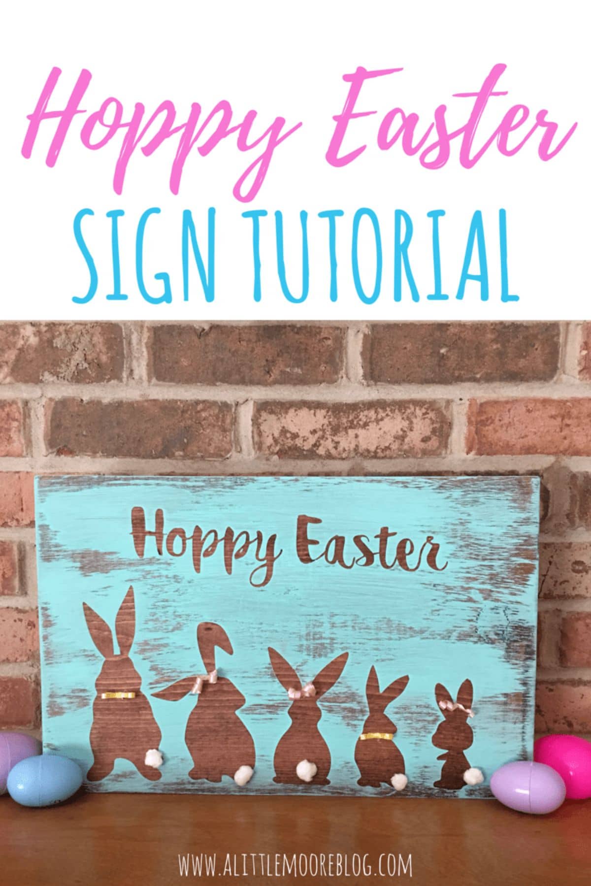 up against a red brick wall sits a wooden sign, with a turquoise background and "Hoppy Easter" at the top. Underneath are 5 bunnies of various sizes