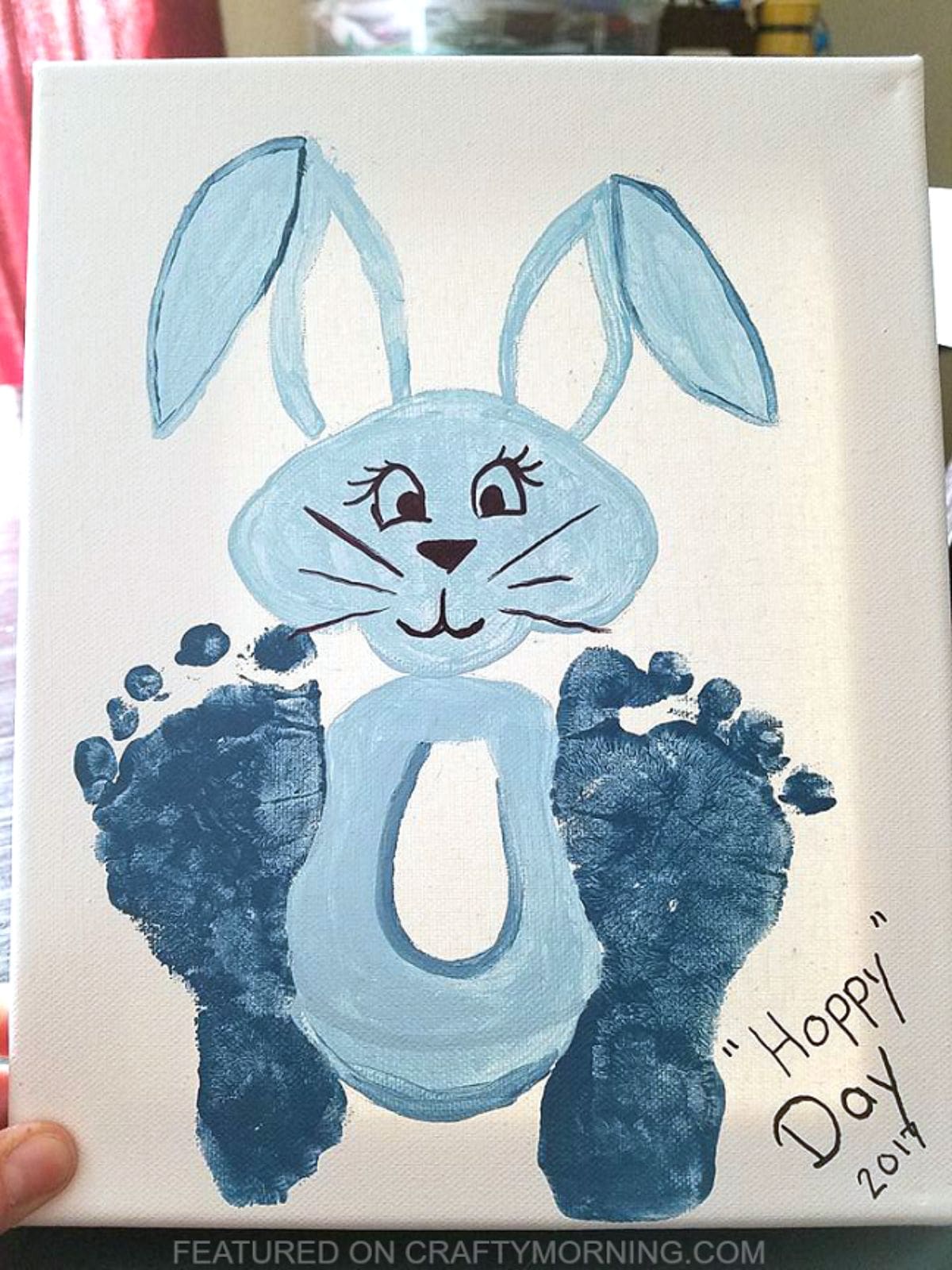 A blue bunny picture with baby footprints as its feet