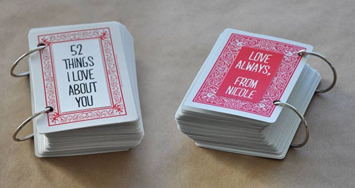 in na cream background sit two playing card sized ringbound books. On the front the text reads "52 Things I love about you" and "Love always, from Nicole"