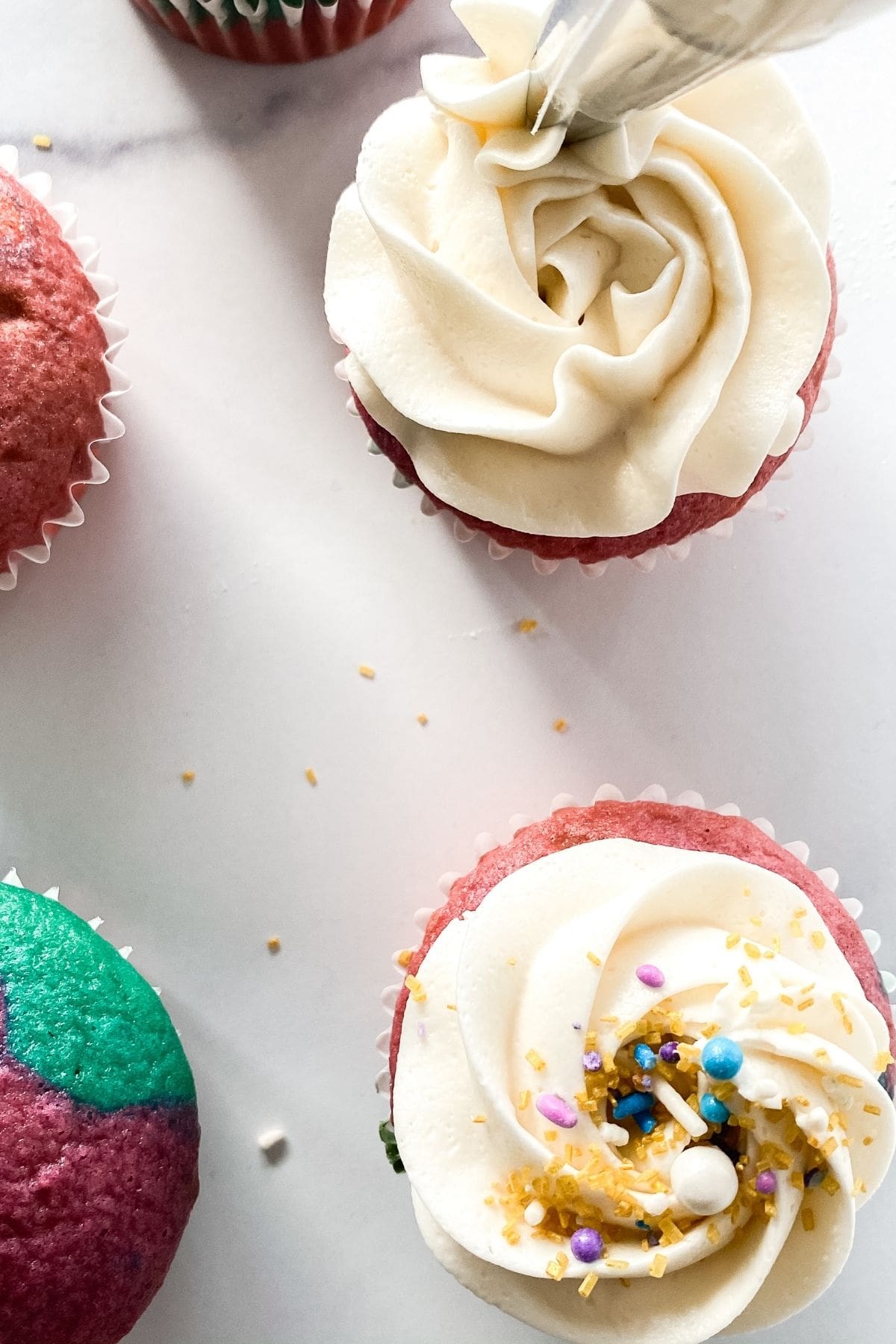 Adding frosting to cupcakes