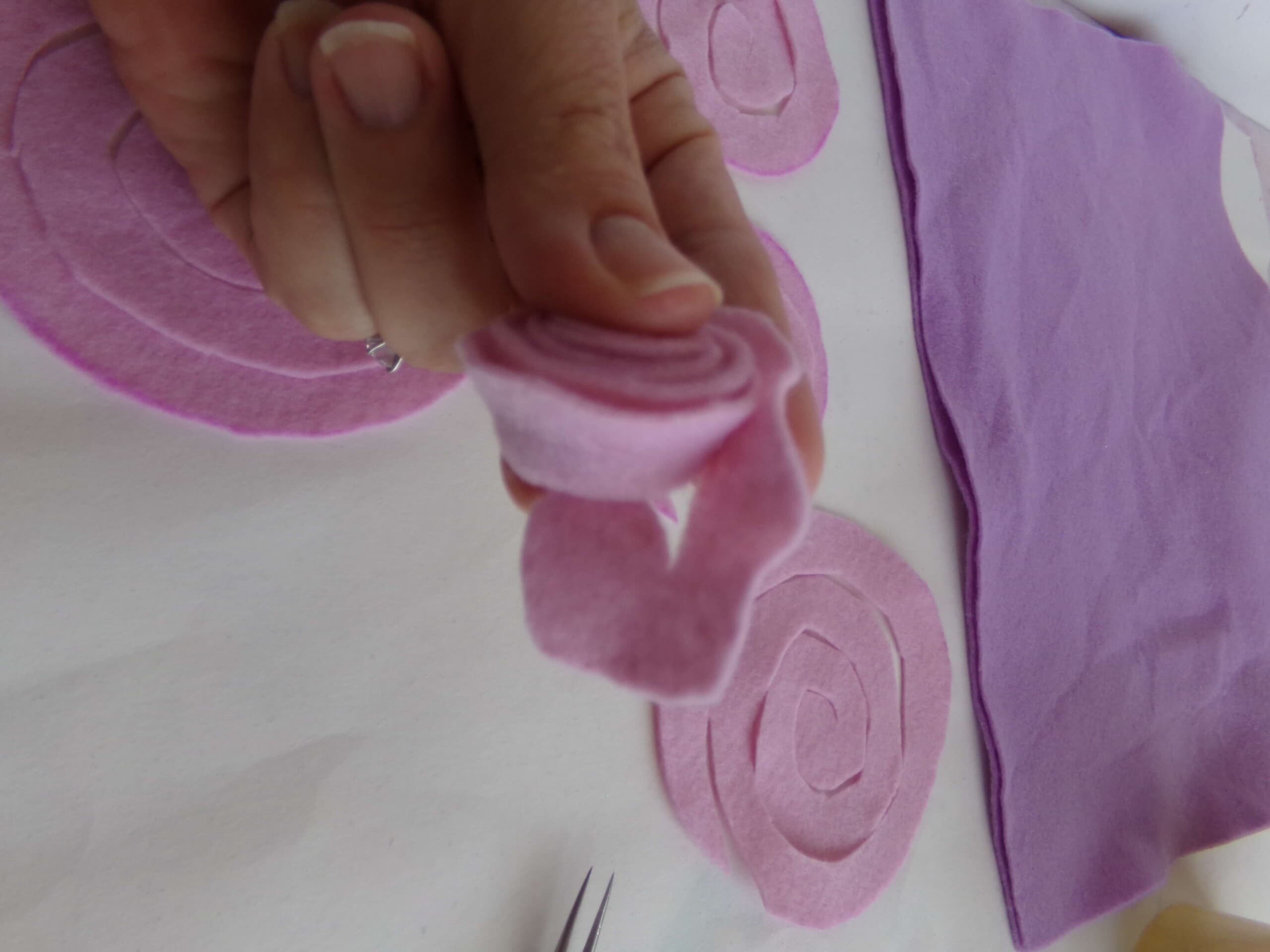 making rolled felt roses for a wreath