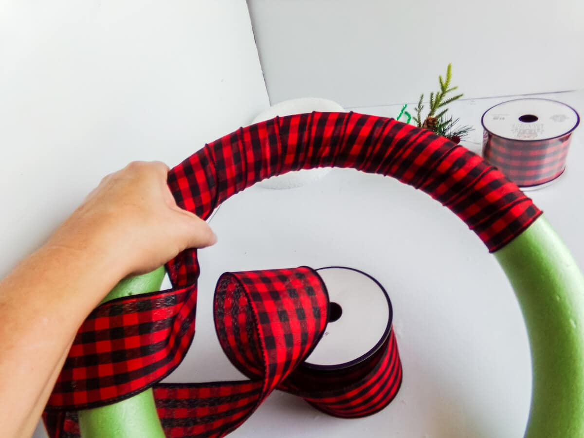 wrapping a wreath form with ribbon to make a holiday mickey wreath