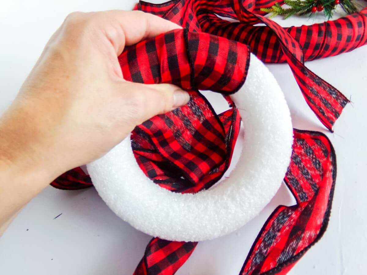 wrapping ribbon around a wreath form to make a mickey buffalo check wreath