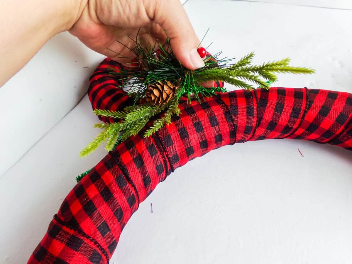 adding greenery to a simple mickey mouse wreath for the holidays