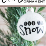 easy cricut christmas ornament craft with text which reads let it snow ornament