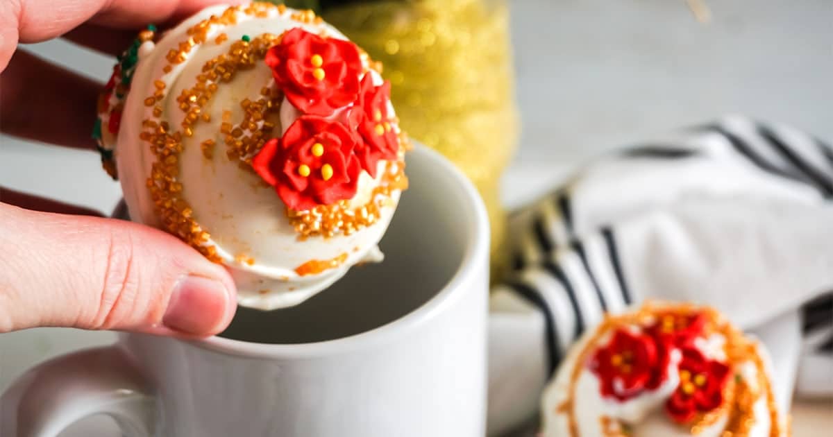 poinsettia hot cocoa bomb recipe being put in a mug