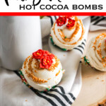 overhead view of christmas hot cocoa bombs with text which reads poinsettia hot cocoa bombs