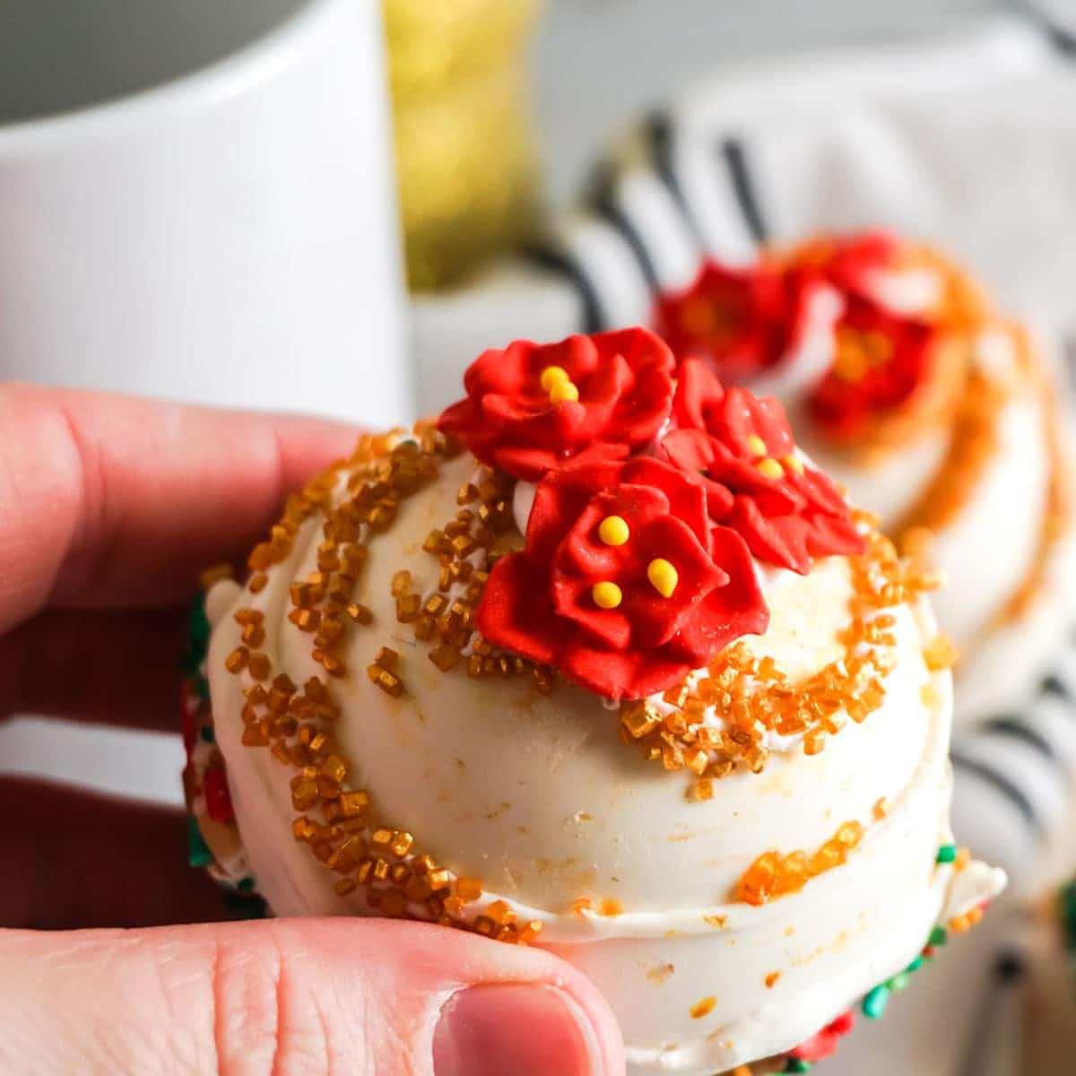 hand holding poinsettia hot cocoa bombs 