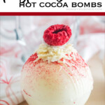 raspberry topped white chocolate hot cocoa bombs with text which reads raspberry hot cocoa bombs