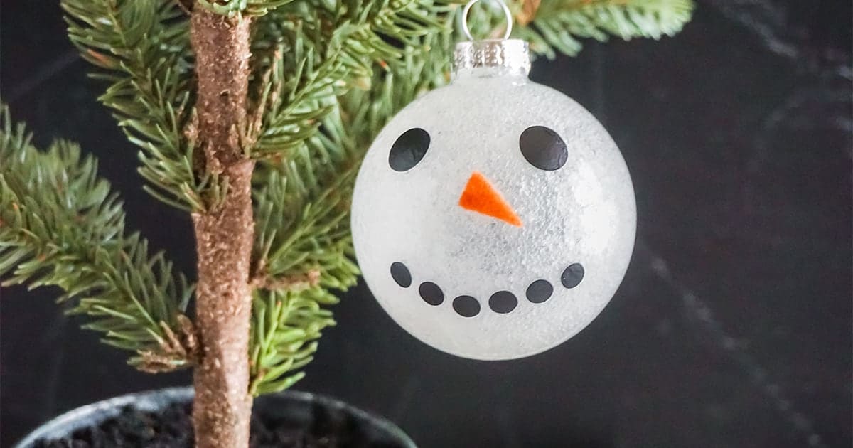 snowman ornament cricut craft hanging from a christmas tree