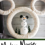 easy snowman mickey wreath for christmas with text which reads Mickey mouse snowman wreath