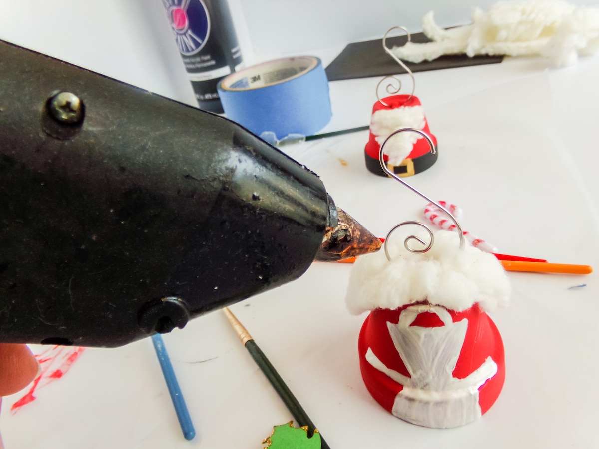 in-process step of making a santa and mrs claus ornaments 