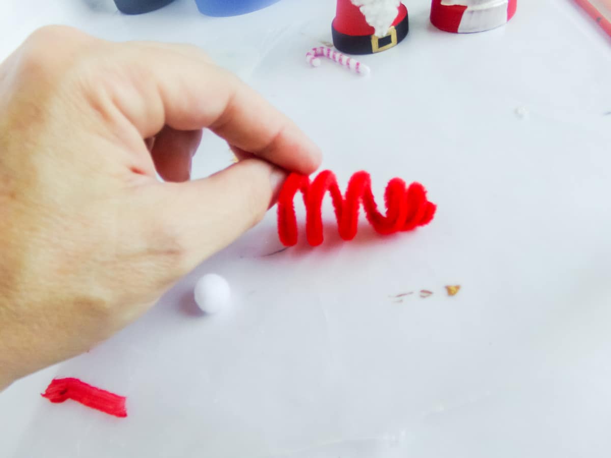 in-process step of making a santa and mrs claus ornaments 