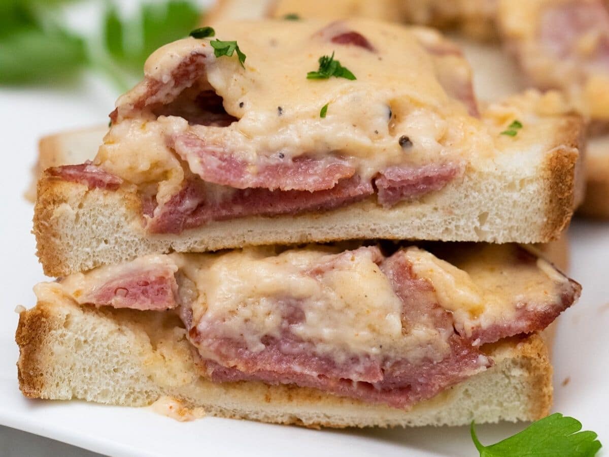 sliced toast topped with gravy and beef on plate