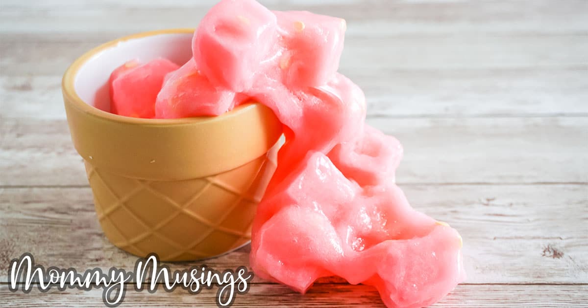 Pink Lemonade Jelly Cube Slime spilling out of a cup onto a table