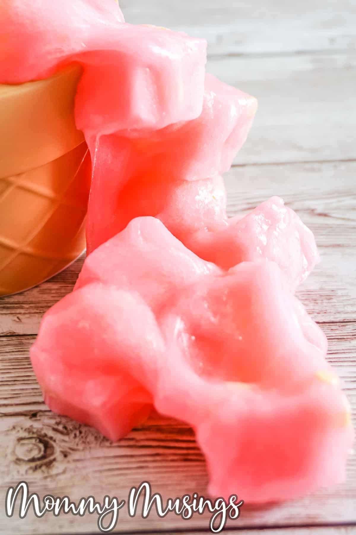 Pink Lemonade Jelly Cube Slime spilling out of a cup onto the table