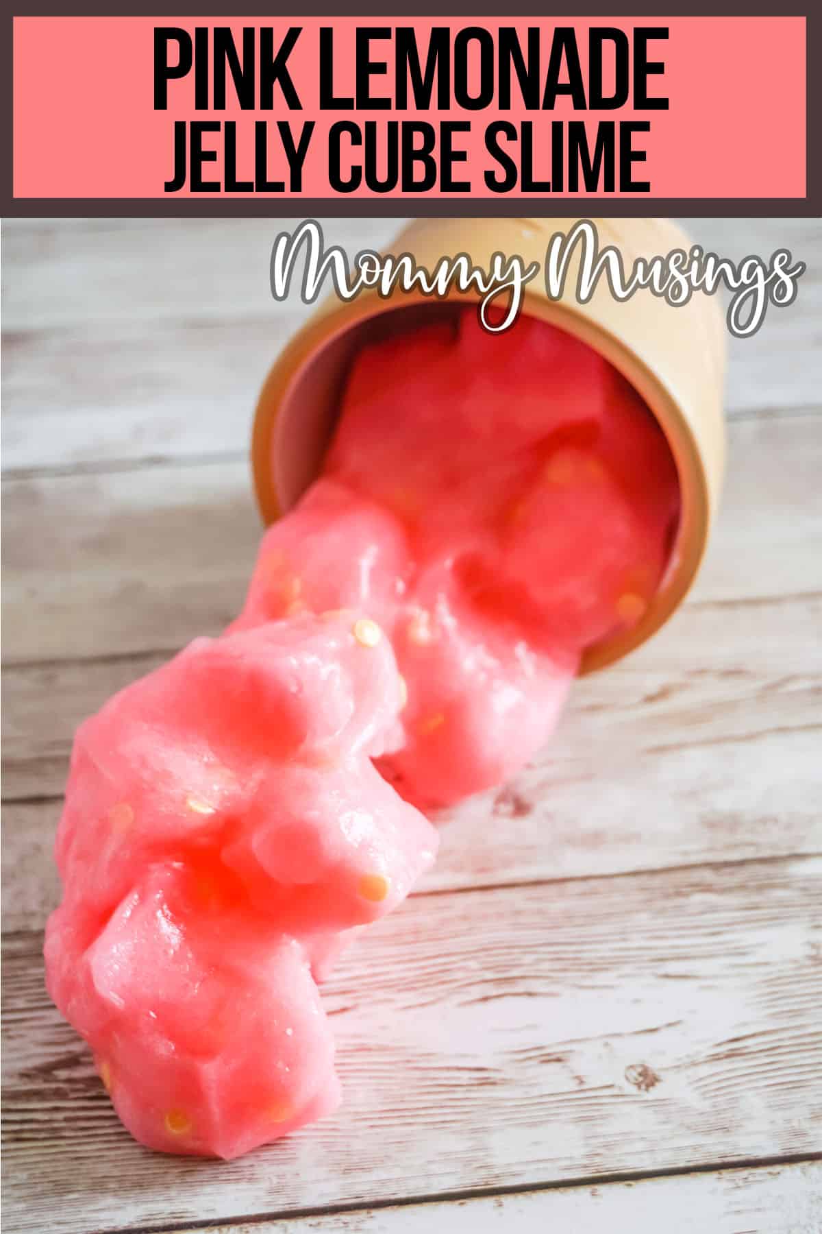 easy diy jelly cube slime spilling out of a cup onto a table with text which reads Pink Lemonade Jelly Cube Slime